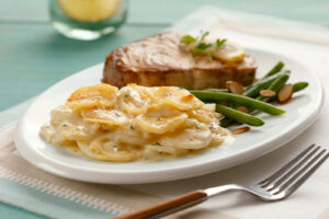 Cheesy Scalloped Homestyle Casserole with pork chops and green beans