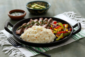 Monterey Pepper Jack Mashed Potatoes with roasted peppers and carne asada