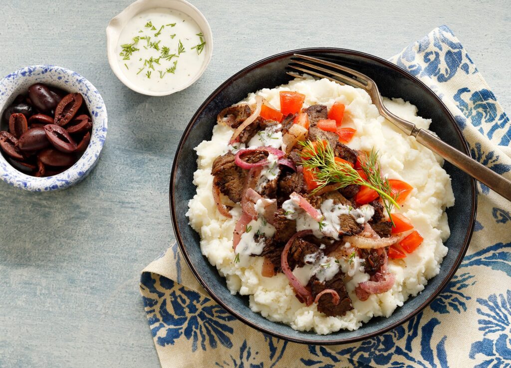 This Greek Mashed Potato Bowl is made with lamb, kalamata olives, sautéed onions, fresh diced tomatoes and, of course, Idahoan mashed potatoes!